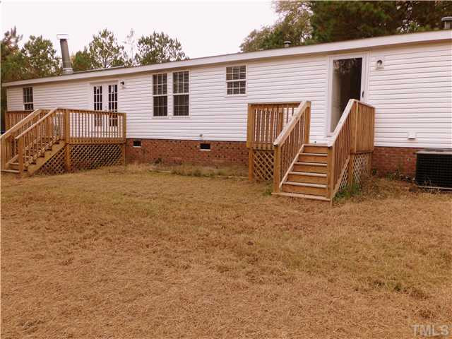 295 Massengill Pond Road Angier, NC 27501 - Photo 21 of 25 a view of house with backyard and trees in the background