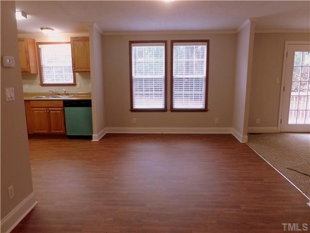295 Massengill Pond Road Angier, NC 27501 - Photo 5 of 25 an empty room with a kitchen and windows