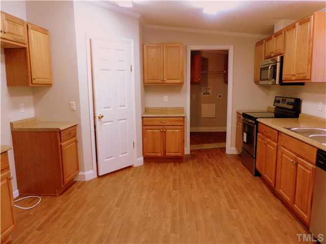 295 Massengill Pond Road Angier, NC 27501 - Photo 6 of 25 a kitchen with stainless steel appliances granite countertop a refrigerator and a stove top oven