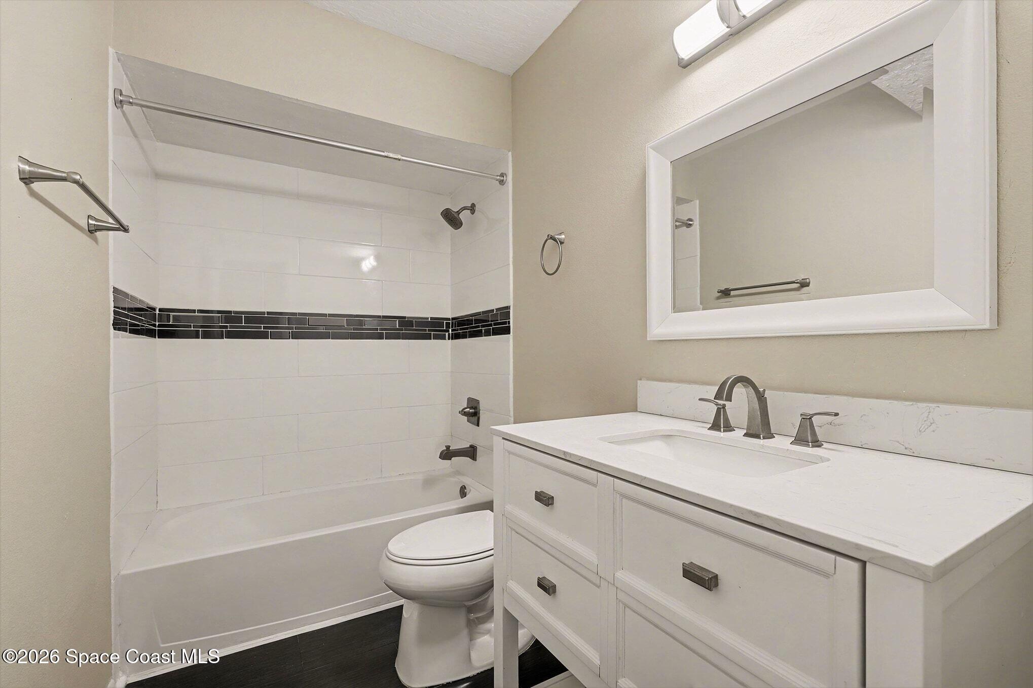 1011 Clearmont Street Northeast, Unit 1022 Palm Bay, FL 32905 - Photo 13 of 16 a bathroom with a sink toilet and shower