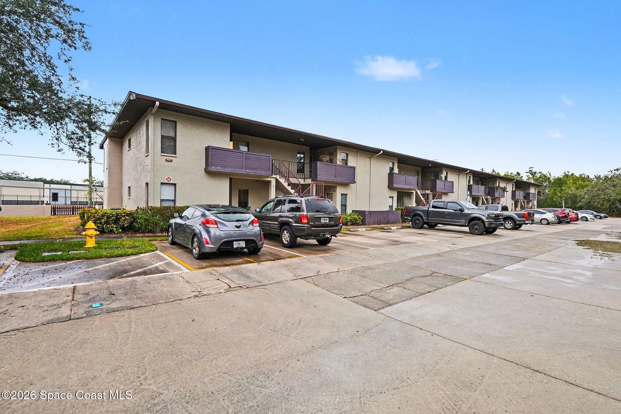 1011 Clearmont Street Northeast, Unit 1022 Palm Bay, FL 32905 - Photo 2 of 16 a view of car parked in front of house