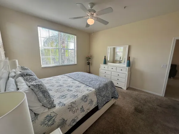 a bedroom with a bed dresser and a window