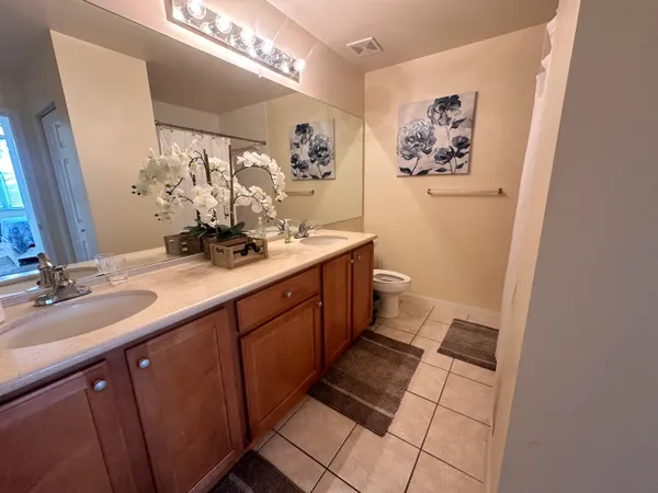 a bathroom with a double vanity sink and a mirror