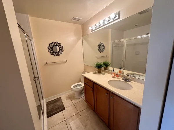 a bathroom with a sink mirror and toilet