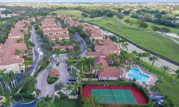 an aerial view of residential houses with outdoor space and street view