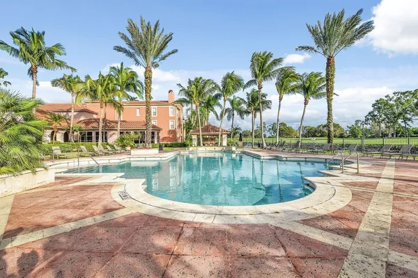 a view of a swimming pool with a table and chairs
