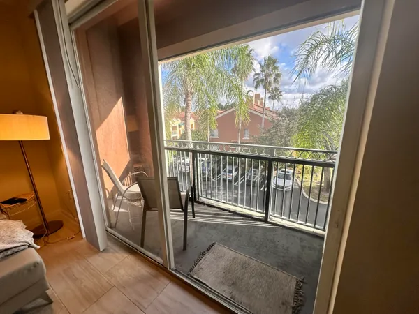 a view of a balcony with wooden floor and door