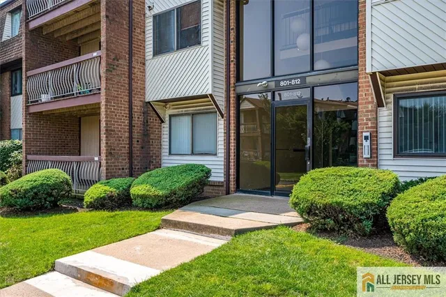 a view of a house with a small yard and a garage