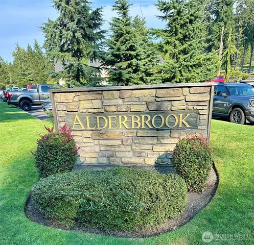 a view of a sign board with a yard