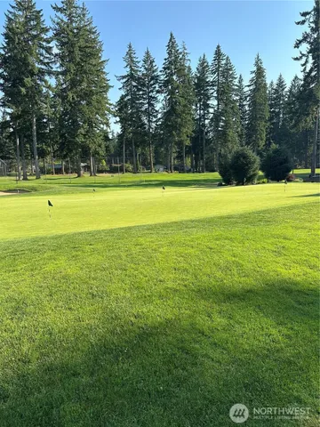 a view of a swimming pool with an outdoor space and seating area