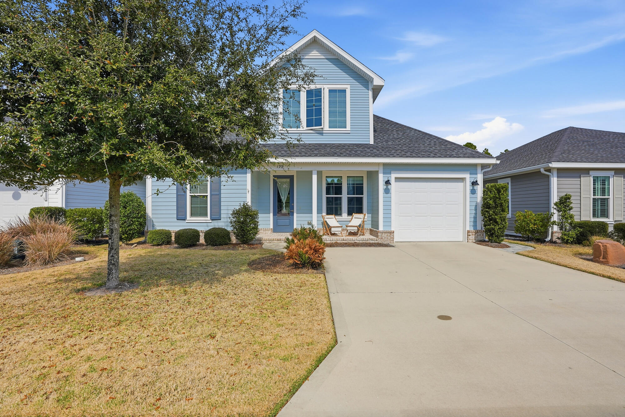 a front view of house with yard and trees around