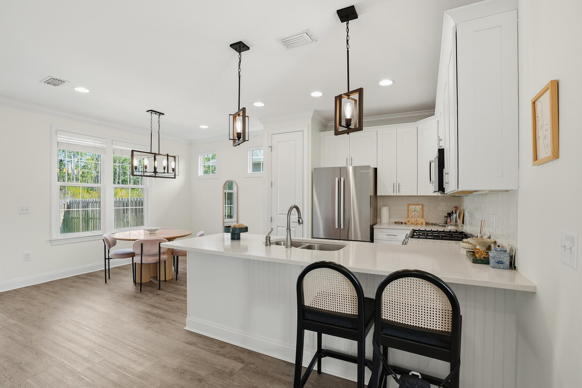 199 Windrow Way Inlet Beach Inlet Beach, FL 32461 - Photo 5 of 24 a kitchen with stainless steel appliances granite countertop a sink a stove and chairs