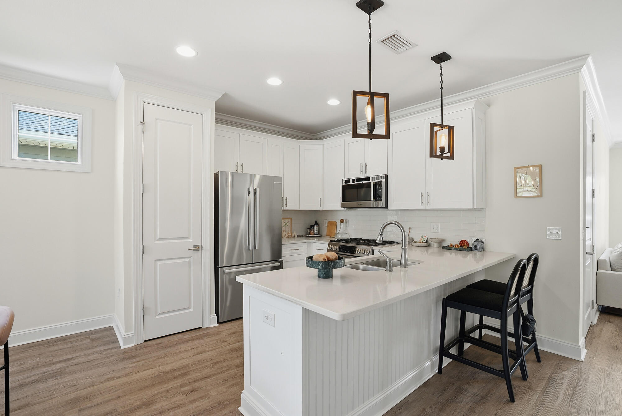 199 Windrow Way Inlet Beach Inlet Beach, FL 32461 - Photo 6 of 24 a kitchen with stainless steel appliances kitchen island a wooden floor and white cabinets