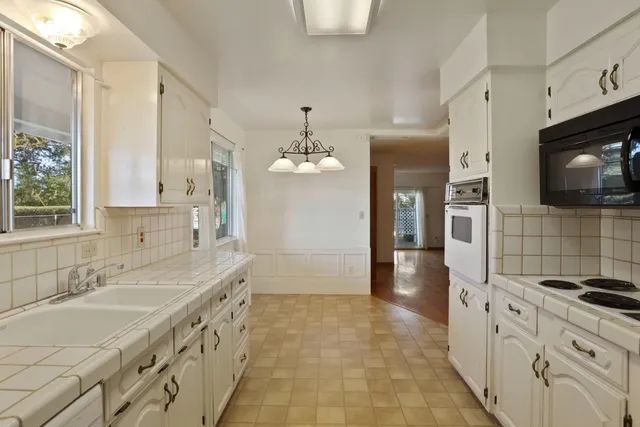 a bathroom with a sink a vanity a mirror and a shower