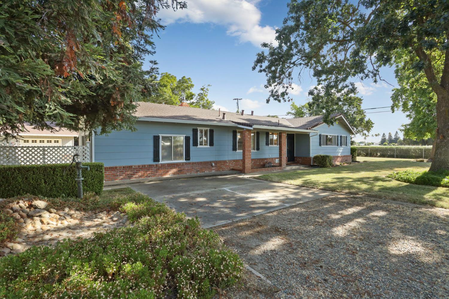 13495 Live Oak Road Lodi, CA 95240 - Photo 2 of 47 a front view of a house with a yard