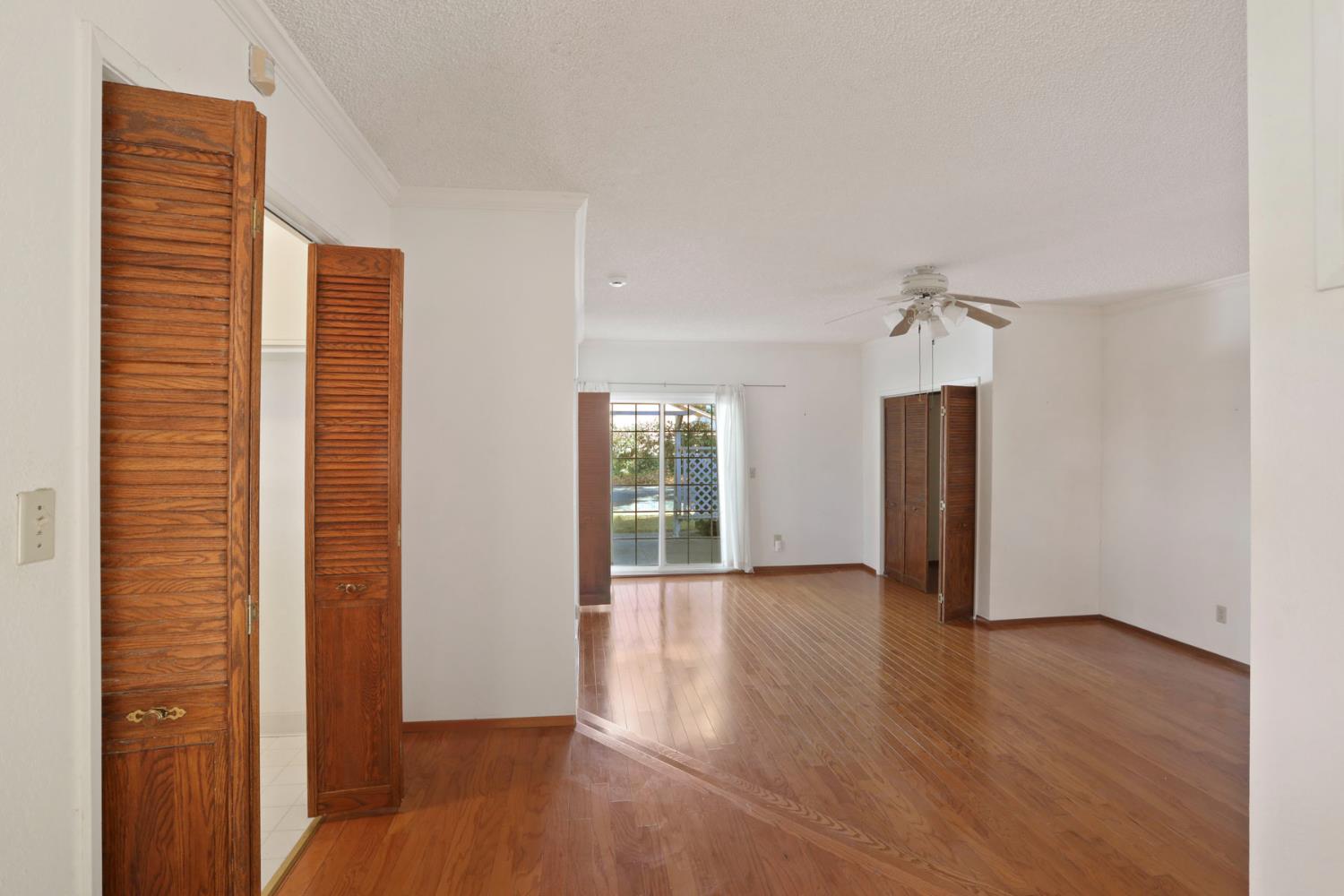 13495 Live Oak Road Lodi, CA 95240 - Photo 22 of 47 an empty room with wooden floor and windows