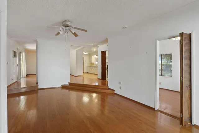 a view of a room with wooden floor and a window