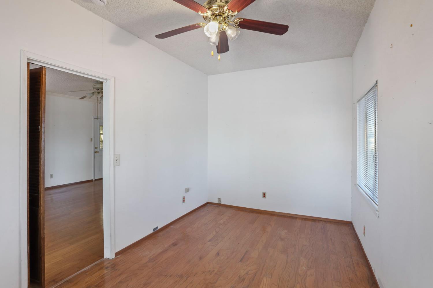 13495 Live Oak Road Lodi, CA 95240 - Photo 28 of 47 an empty room with closet and a chandelier fan