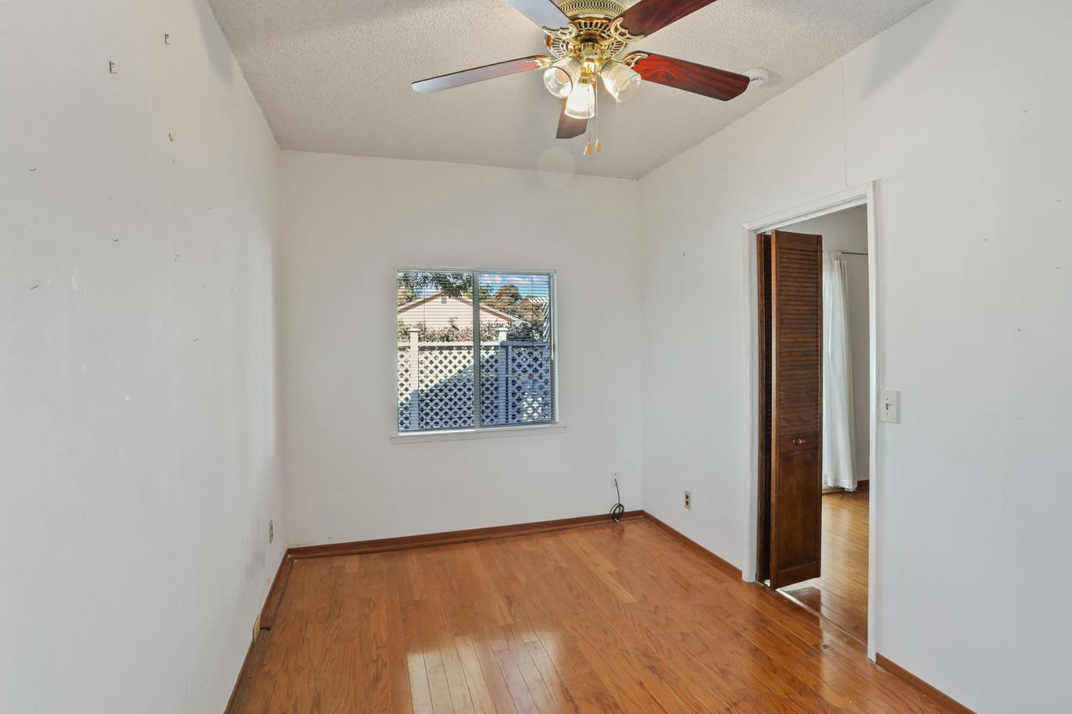13495 Live Oak Road Lodi, CA 95240 - Photo 29 of 47 an empty room with wooden floor closet and windows