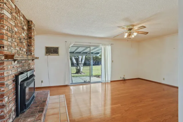 wooden floor in an empty room with a fireplace