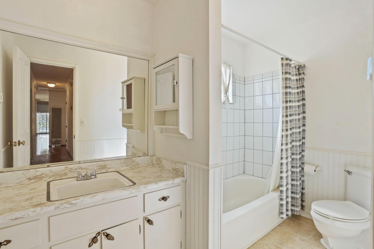 13495 Live Oak Road Lodi, CA 95240 - Photo 39 of 47 a bathroom with a granite countertop sink a toilet and shower