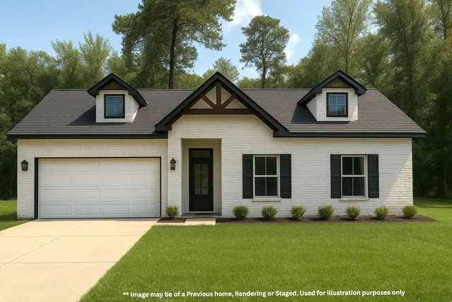 a front view of a house with a garden and yard