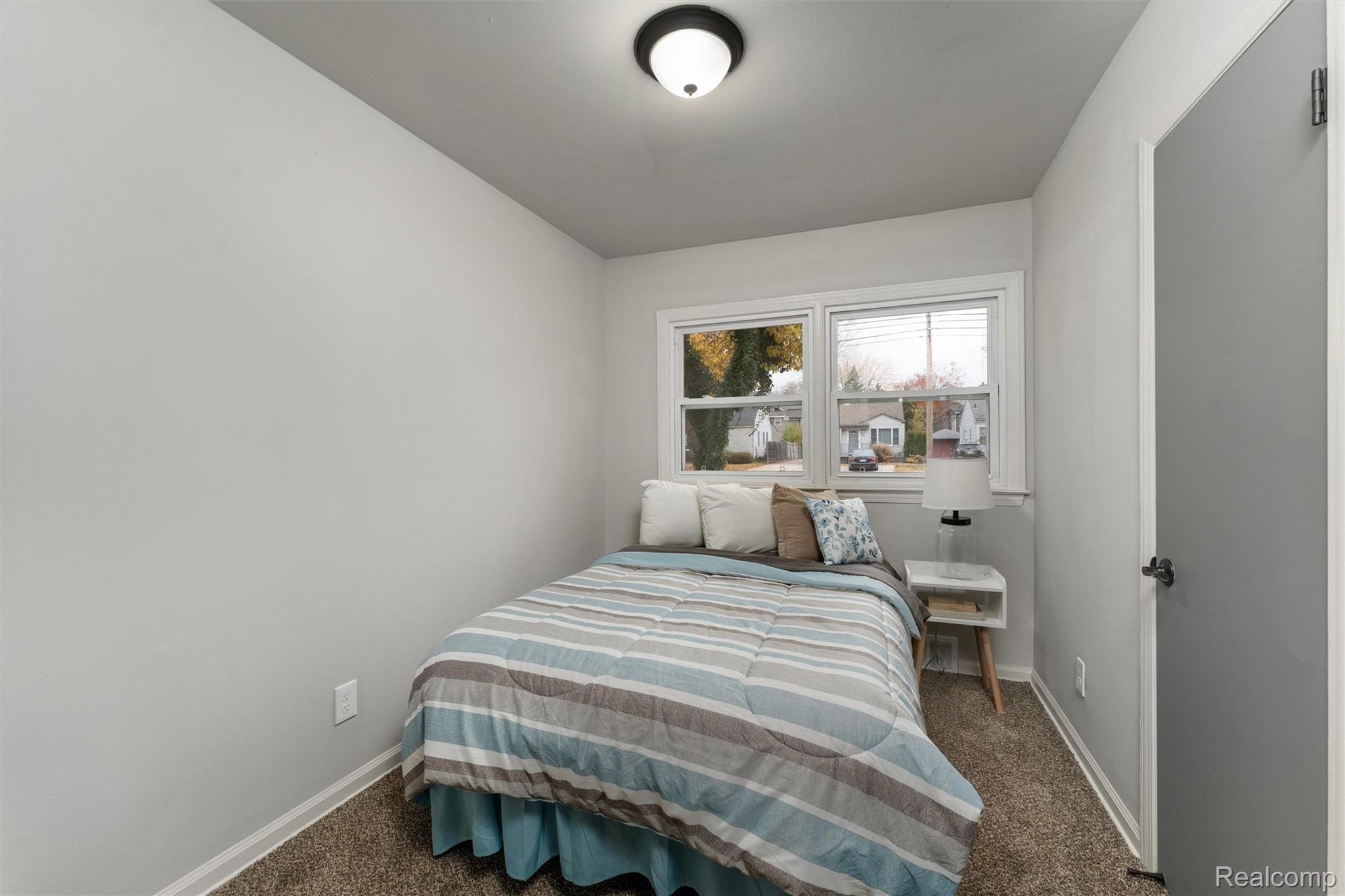15751 West 14 Mile Road Franklin, MI 48025 - Photo 10 of 24 Bedroom featuring neutral wall paint, white trim, two windows with blinds, and brown carpet flooring