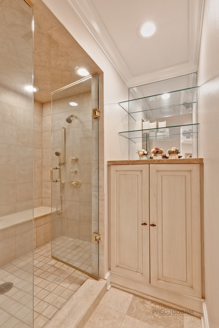 575 West Windsor Road Inverness, IL 60067 - Photo 27 of 54 a bathroom with a glass shower door