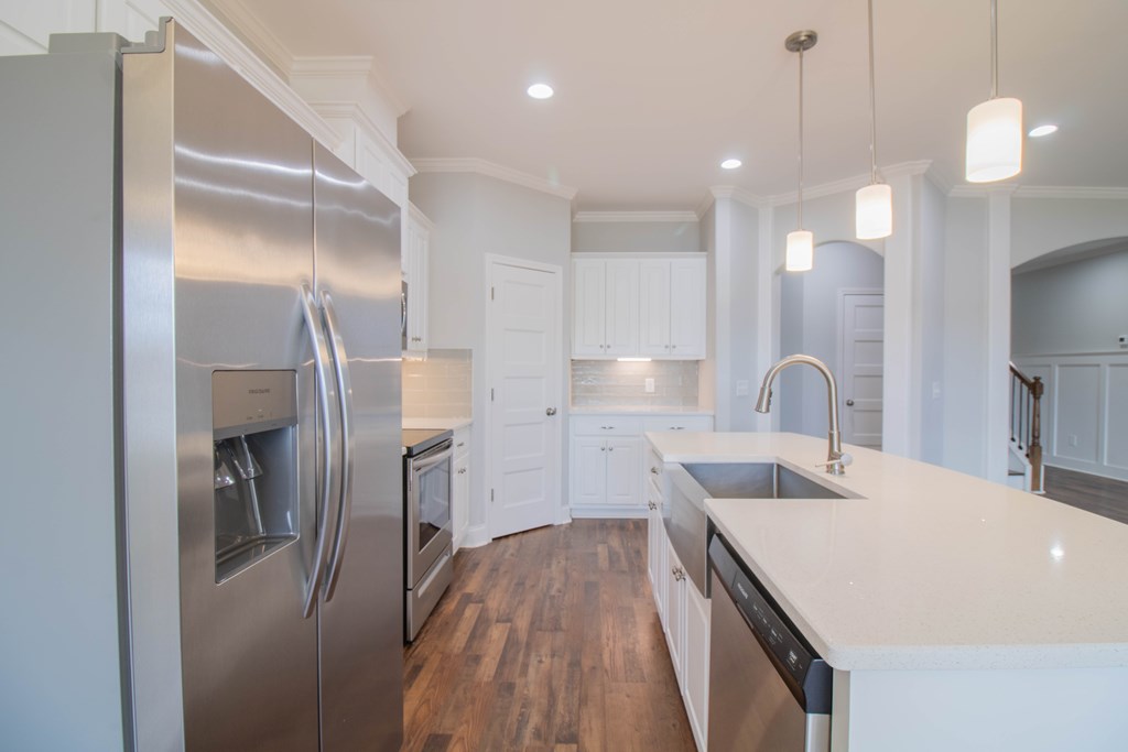 9605 Capot Drive Midland, GA 31820 - Photo 11 of 38 a kitchen with a refrigerator a sink and wooden floor