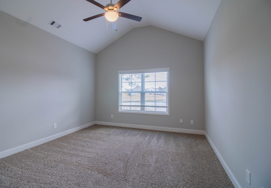 9605 Capot Drive Midland, GA 31820 - Photo 21 of 38 an empty room with a window and a fan
