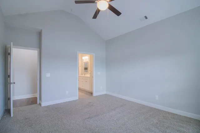 an empty room with a empty space and chandelier fan