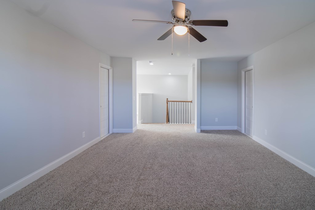 9605 Capot Drive Midland, GA 31820 - Photo 29 of 38 an empty room with a ceiling fan and a window