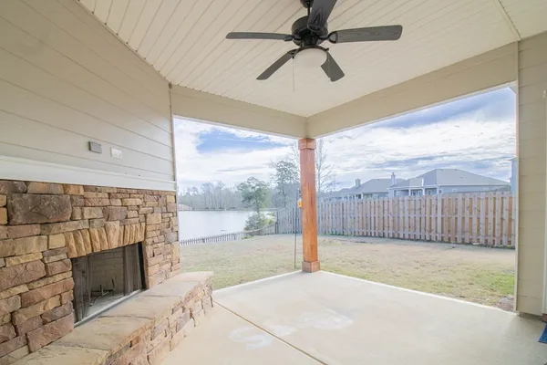 a view of livingroom with a ceiling fan and a fireplace