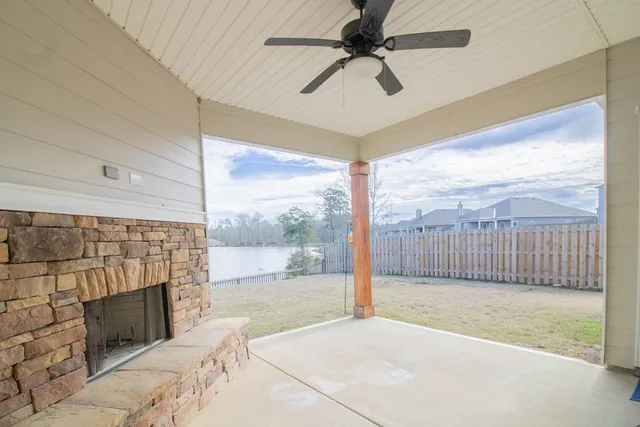 a view of livingroom with a ceiling fan and a fireplace