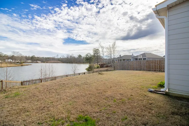 a view of swimming pool outdoor seating and yard in back