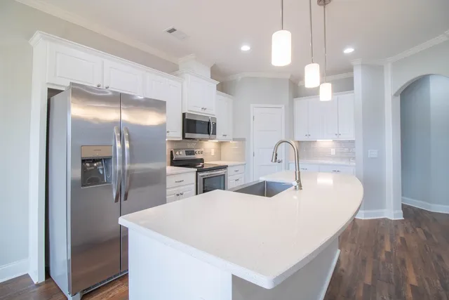 a kitchen with sink refrigerator and microwave