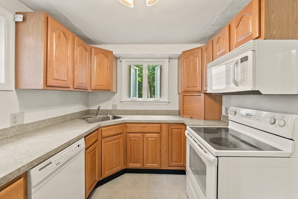 291 Maple Road Longmeadow, MA 01106 - Photo 11 of 26 a kitchen with a sink cabinets and window