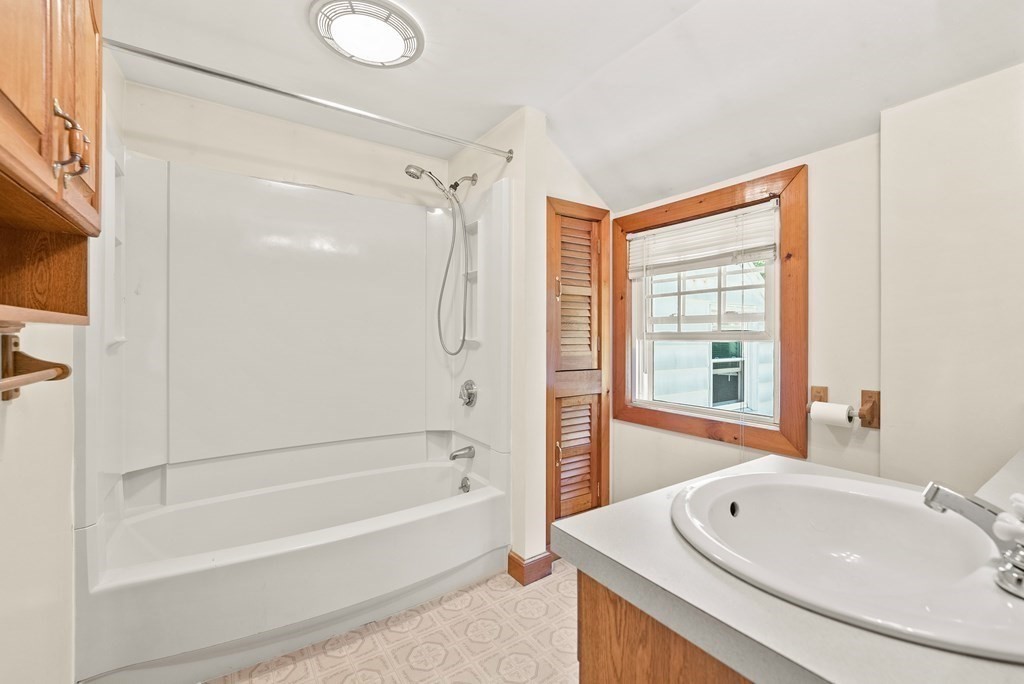 291 Maple Road Longmeadow, MA 01106 - Photo 12 of 26 a bathroom with a tub sink toilet and a window