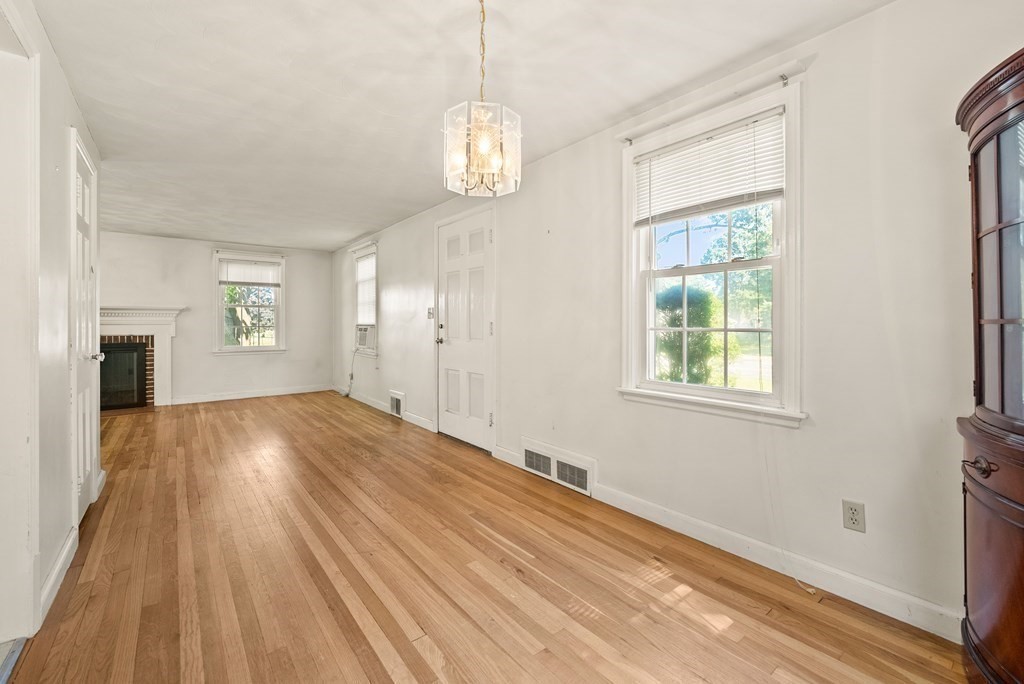 291 Maple Road Longmeadow, MA 01106 - Photo 3 of 26 a view of an empty room with a window and wooden floor