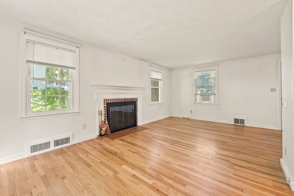 291 Maple Road Longmeadow, MA 01106 - Photo 5 of 26 a view of an empty room with wooden floor and a window