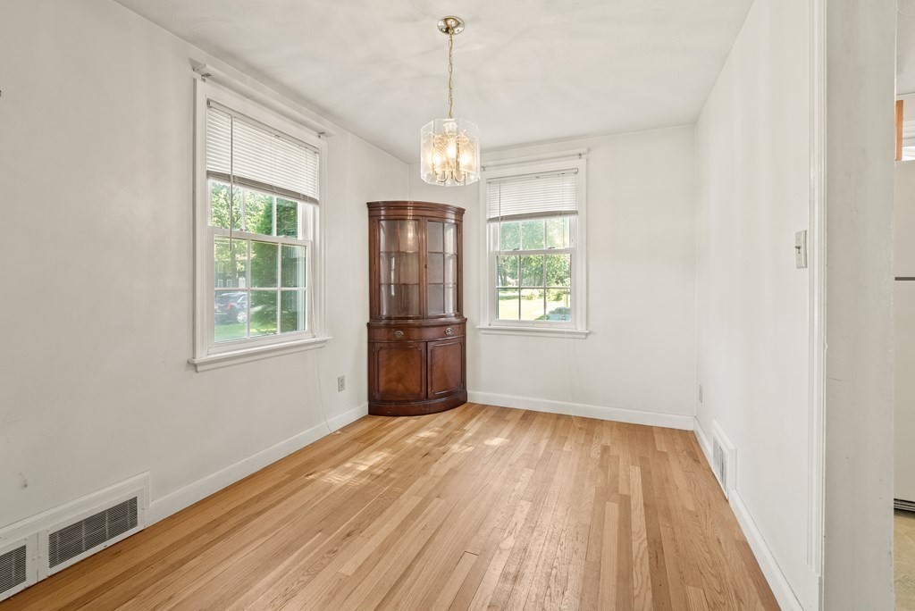 291 Maple Road Longmeadow, MA 01106 - Photo 8 of 26 a view of an empty room with wooden floor and a window