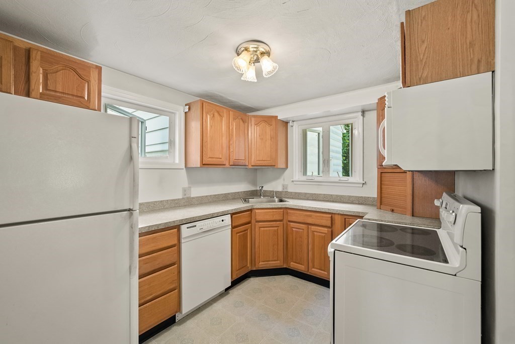 291 Maple Road Longmeadow, MA 01106 - Photo 10 of 26 a kitchen with a sink and a refrigerator