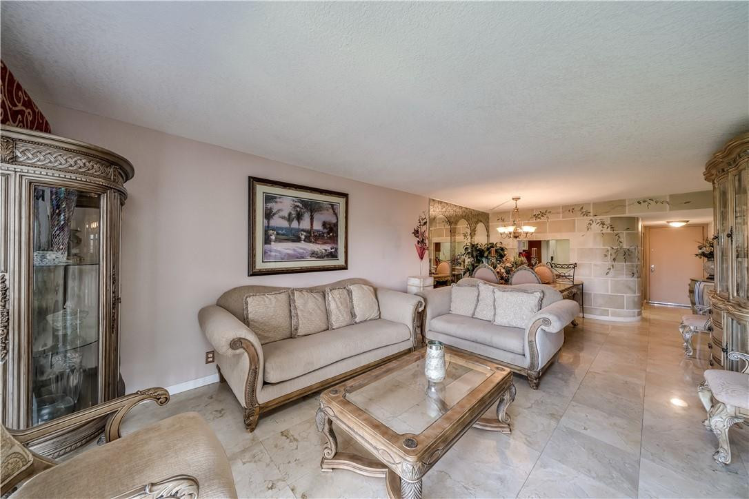 3955 North Nob Hill Road, Unit 408 Sunrise, FL 33351 - Photo 11 of 34 a living room with furniture and a glass door
