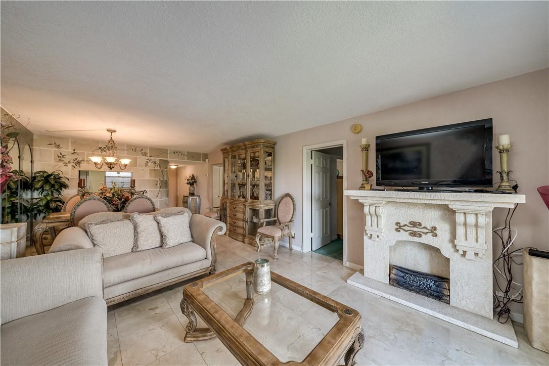 3955 North Nob Hill Road, Unit 408 Sunrise, FL 33351 - Photo 12 of 34 a living room with furniture and a flat screen tv