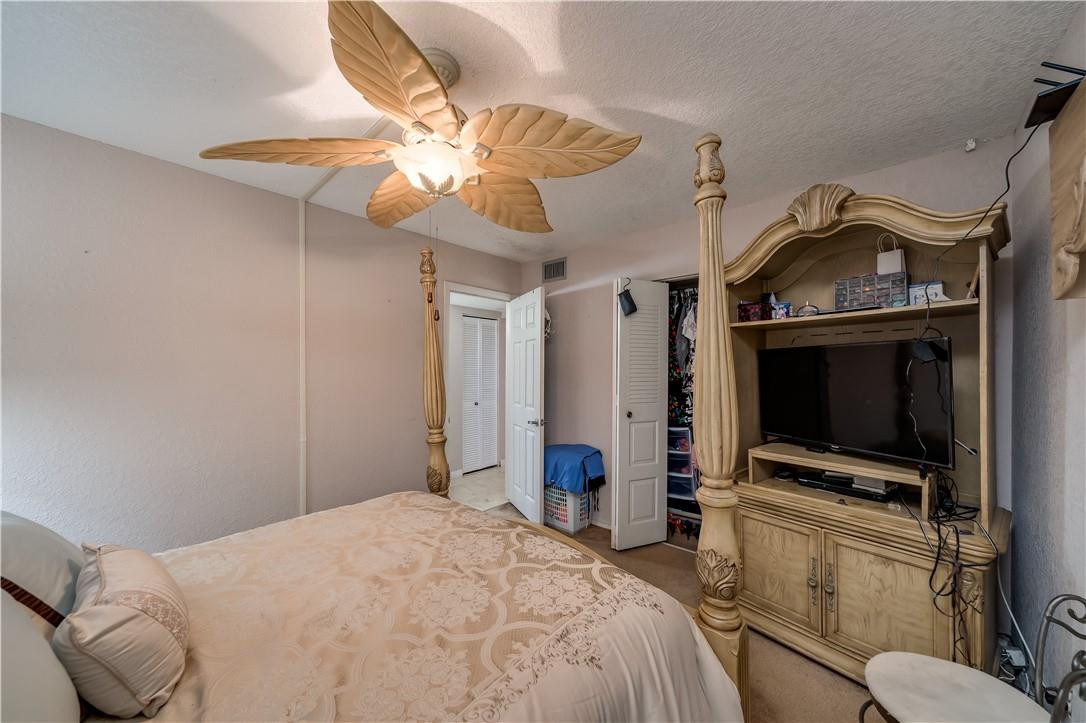 3955 North Nob Hill Road, Unit 408 Sunrise, FL 33351 - Photo 14 of 34 a bedroom with a bed and a flat tv screen on the dresser