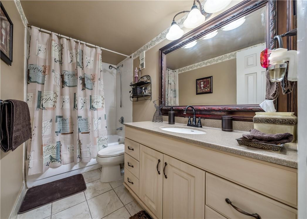 3955 North Nob Hill Road, Unit 408 Sunrise, FL 33351 - Photo 16 of 34 a spacious bathroom with a granite countertop sink a toilet a mirror and shower
