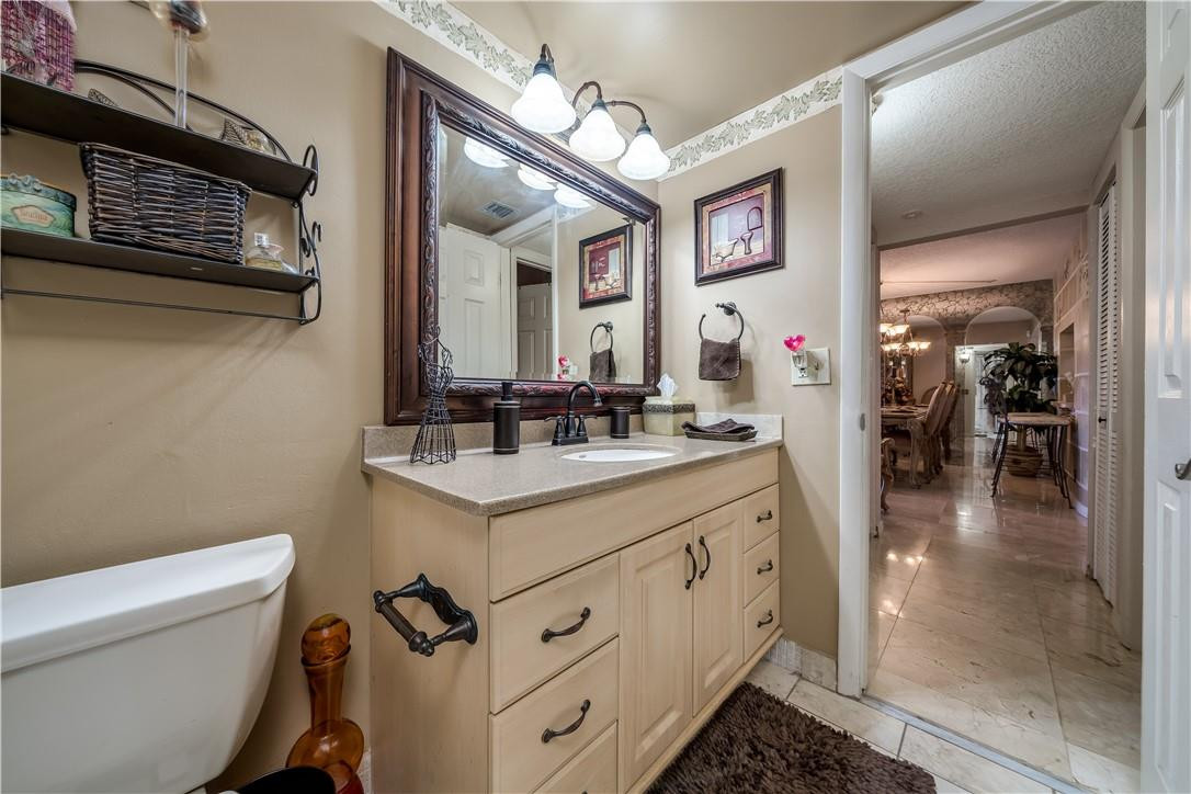 3955 North Nob Hill Road, Unit 408 Sunrise, FL 33351 - Photo 17 of 34 a bathroom with a sink a toilet and mirror