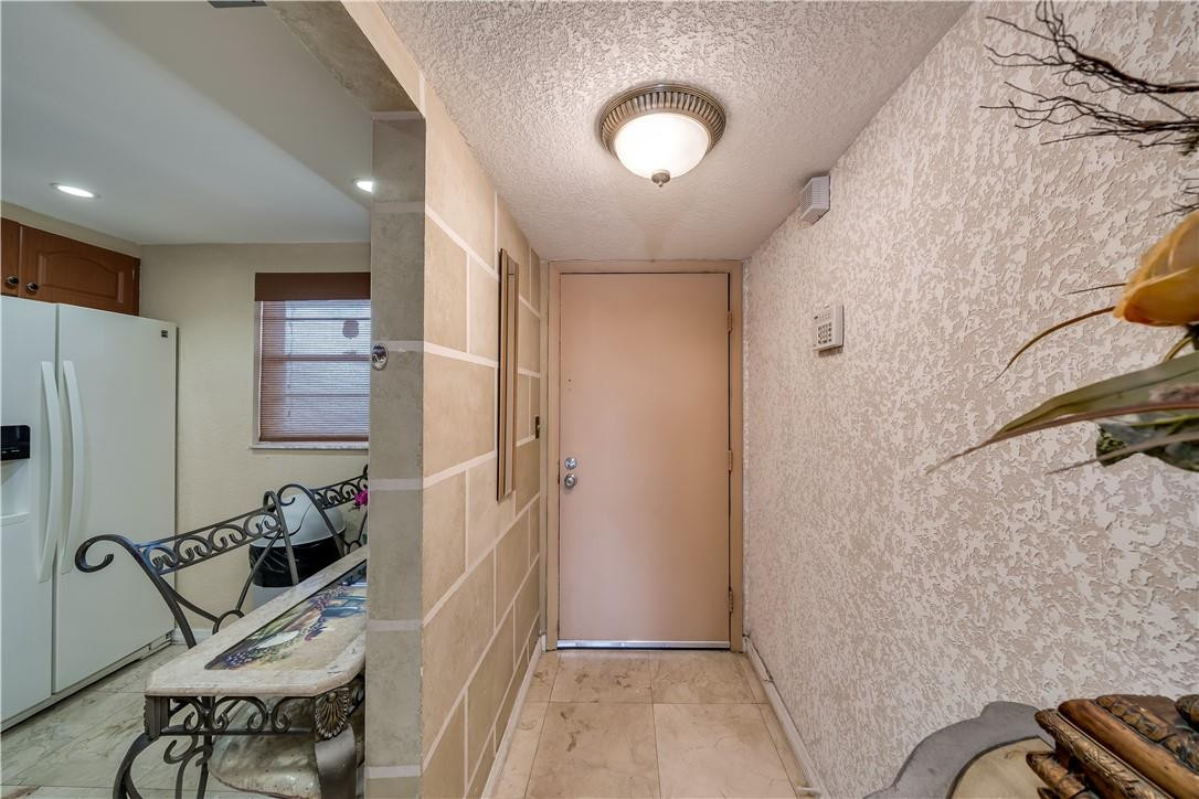 3955 North Nob Hill Road, Unit 408 Sunrise, FL 33351 - Photo 2 of 34 a view of a hallway to a livingroom with furniture and windows