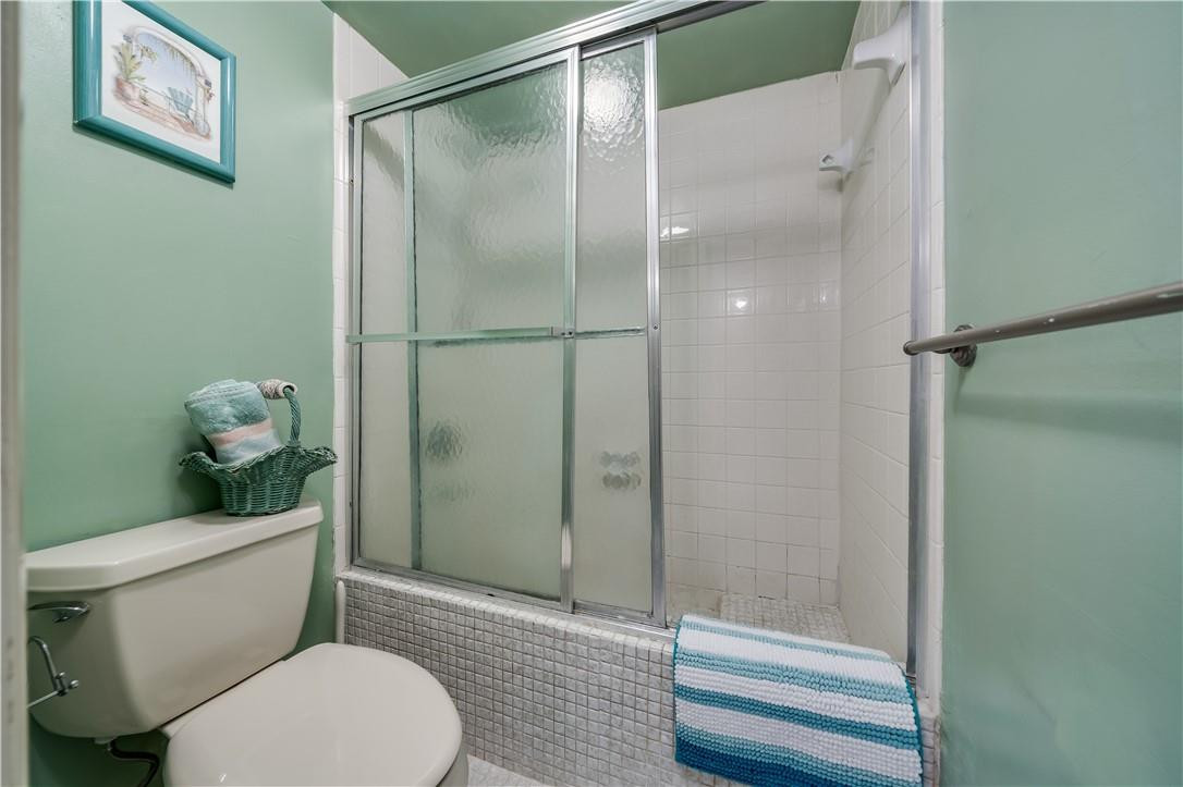3955 North Nob Hill Road, Unit 408 Sunrise, FL 33351 - Photo 21 of 34 a white toilet sitting next to a bathroom sink