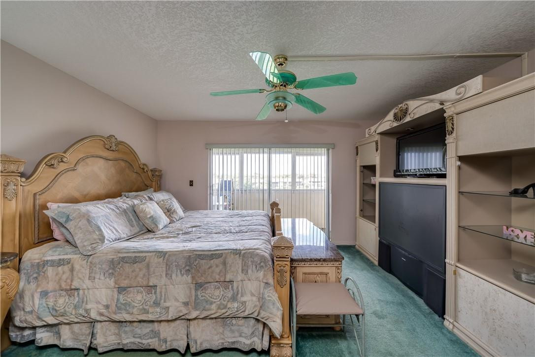 3955 North Nob Hill Road, Unit 408 Sunrise, FL 33351 - Photo 23 of 34 a bedroom with a bed and ceiling fan